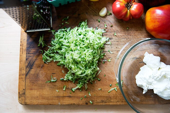 Grated cucumber on a cutting board.