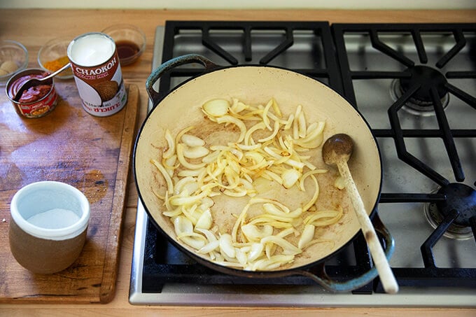 Onions sautéing in a large sauté pan.