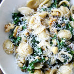 A plate of pasta with Swiss chard, brown butter, and walnuts.