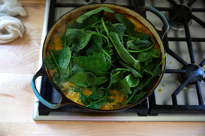 A sauté pan with a heap of spinach.