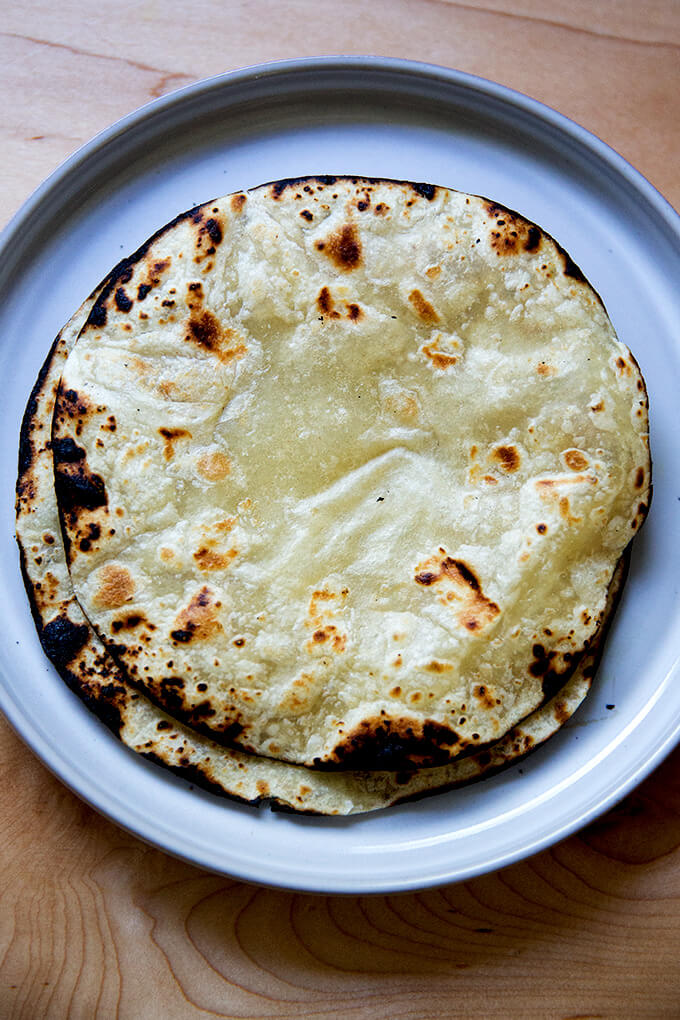 A plate of 2 charred tortillas.