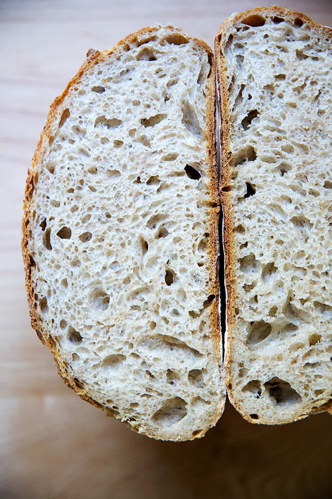 A halved loaf of high hydration sourdough bread.