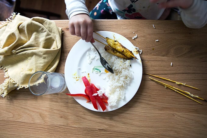 Tig, my daughter, eating her Thai chicken satay and coconut rice.