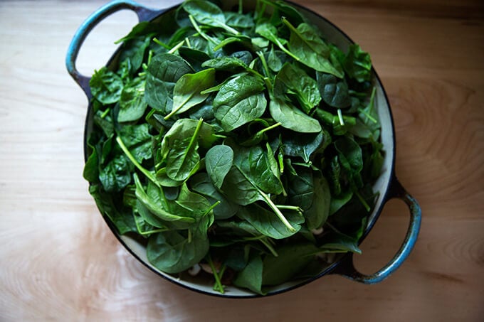 A heap of spinach in a braiser.