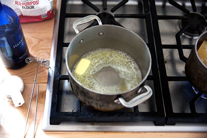 A saucepan filled with melted butter.