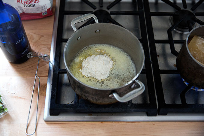 A saucepan filled with melted butter and flour.