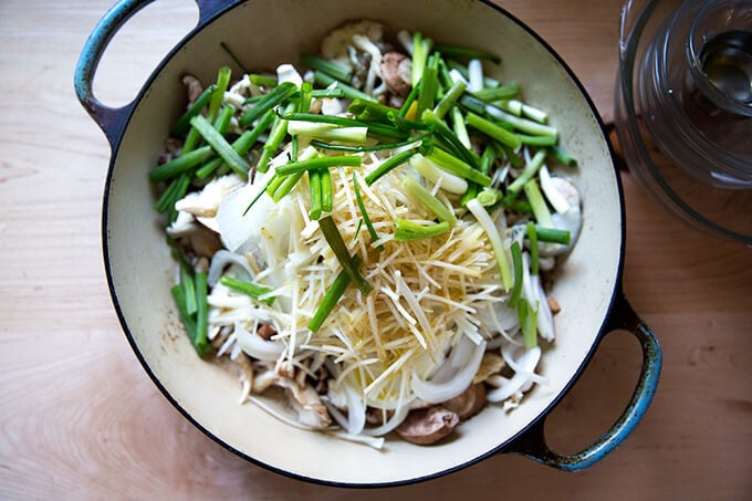 Chopped mushrooms, scallions, onions, and carrots in a Le Creuset braiser.