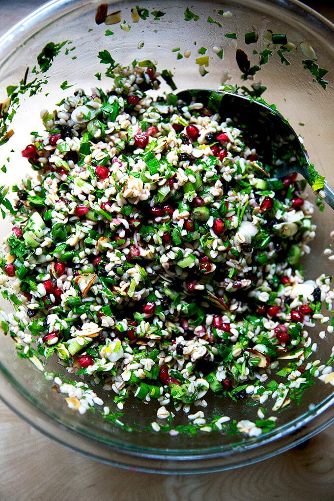 An overhead shot of a glass bowl filled with winter tabbouleh.