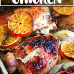 A Roasting pan filled with roast chicken and clementines.