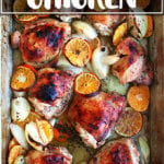 A Roasting pan filled with roast chicken and clementines.