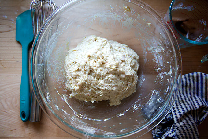 Just-mixed buttermilk pull-apart bread dough in a large glass bowl.