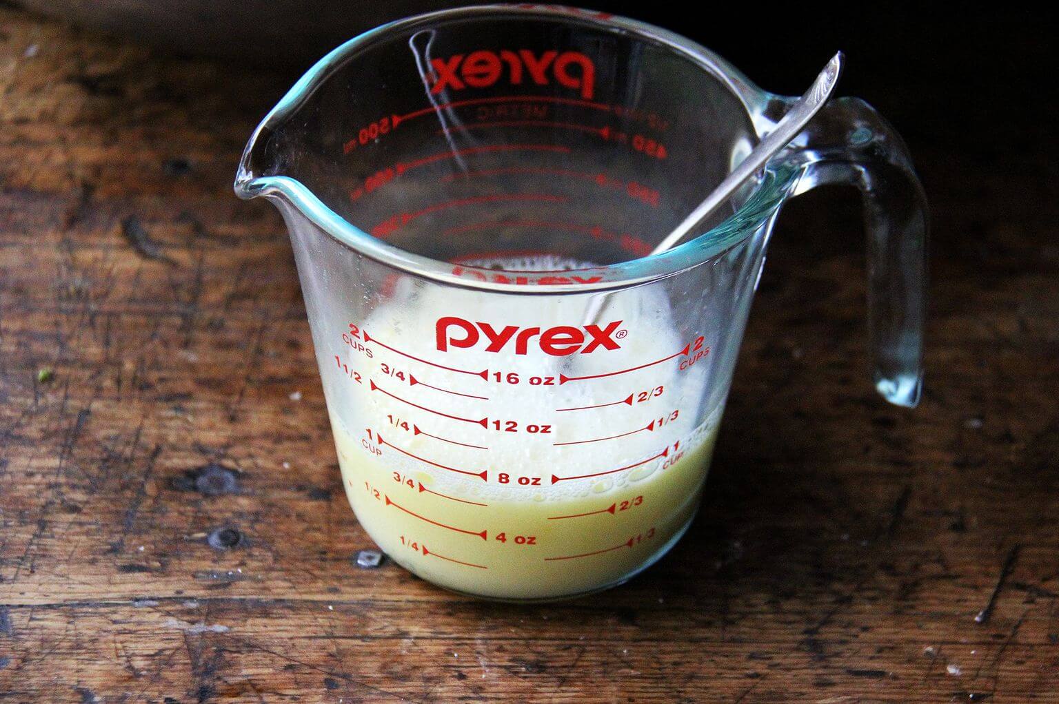 A liquid measure filled with an egg whisked with stock.