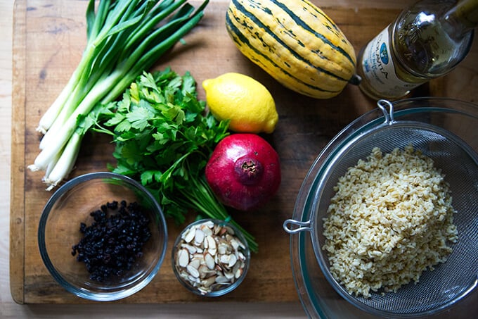 An overhead shot of cutting board filled with the ingredients to make winter tabbouleh.