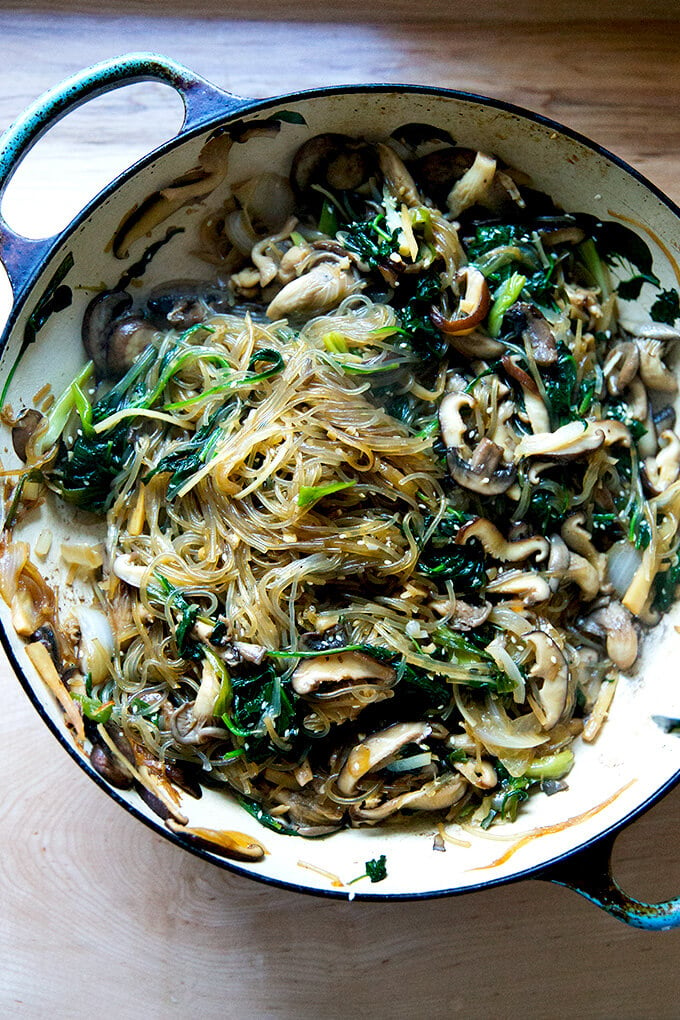 A braiser with cooked Japchae.