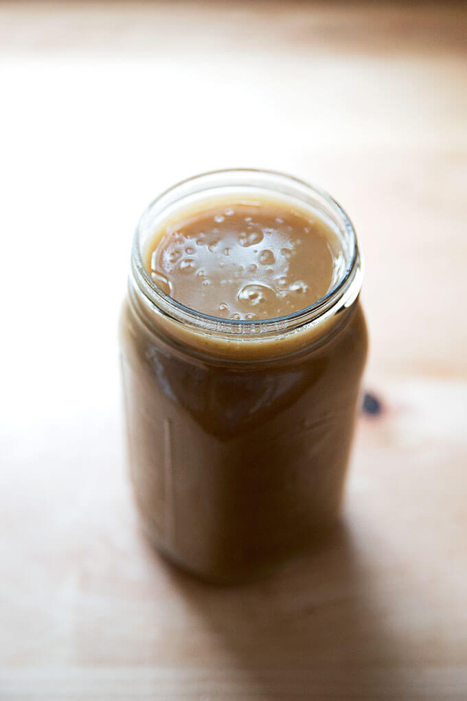 A large Mason jar filled with make-ahead gravy.