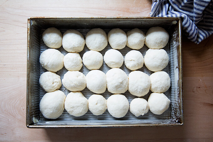 An overhead shot of formed but unbaked pull-apart rolls in a 9x13-inch pan.