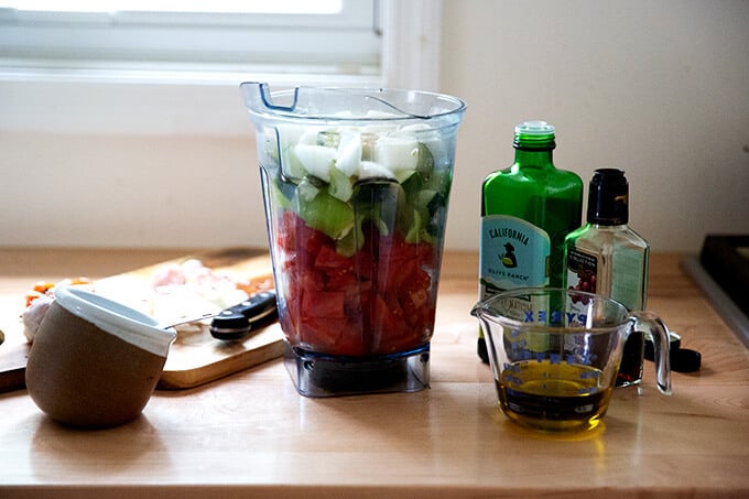 A vitamix filled with vegetables.