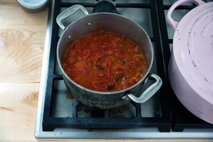 A saucepan filled with vodka sauce simmering.