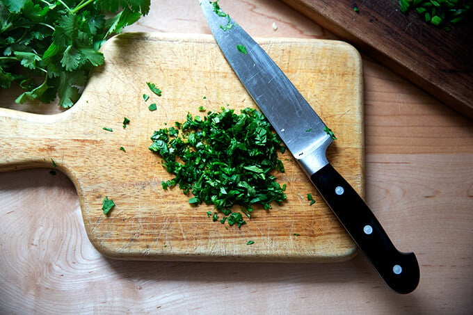 Chopped cilantro on a board.