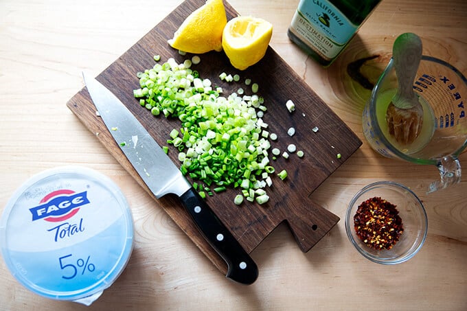 Chopped scallions on a board.