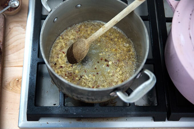 A saucepan filled with butter, garlic, and crushed red pepper flakes.