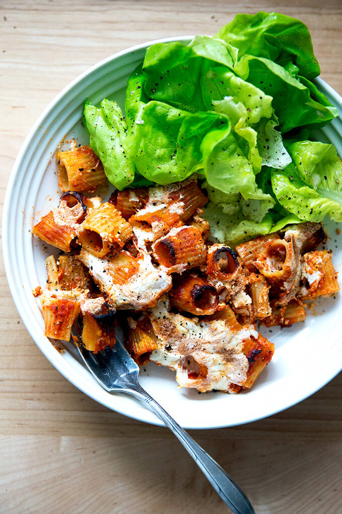 A bowl of just-baked penne alla vodka aside salad.