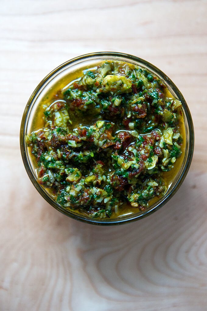 An overhead shot of a bowl holding sun dried-tomato pesto.