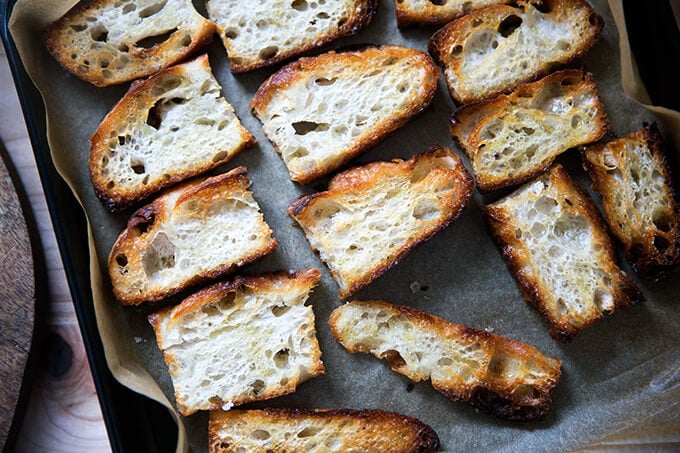 Olive oil toasted bread on a sheet pan.