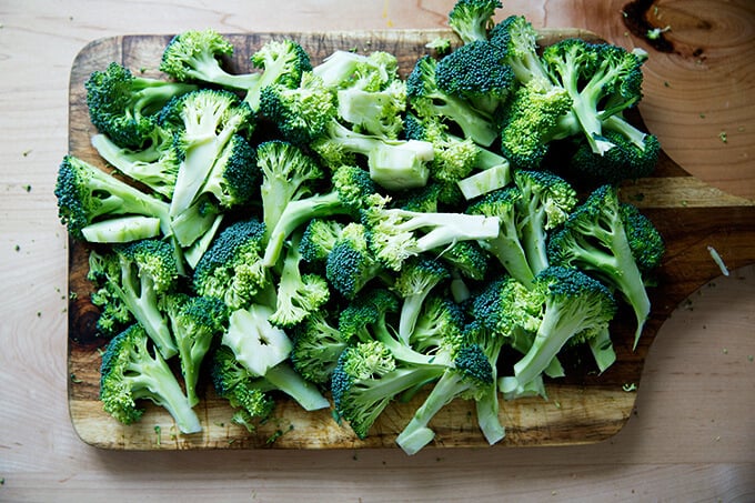 Chopped broccoli on a board.