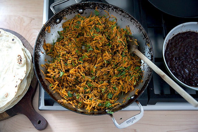 Overhead shot of a skillet holding sweet potato taco filling.