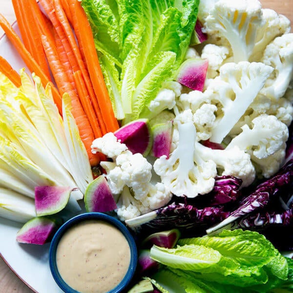 A platter of crudités with spicy cashew dip.