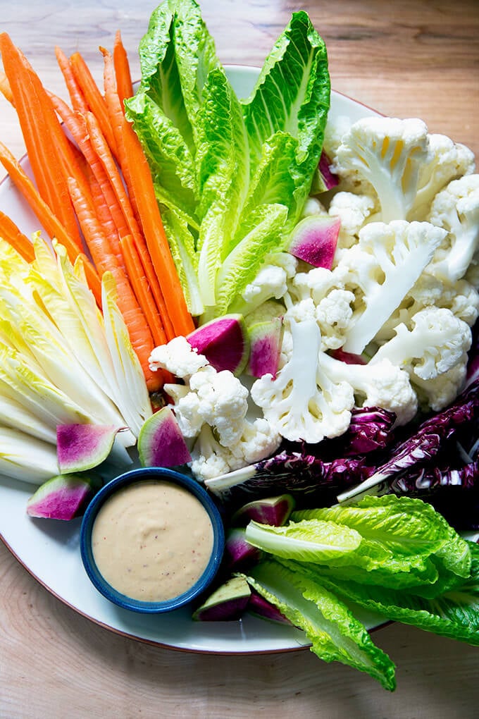 A platter of crudités with spicy cashew dip.