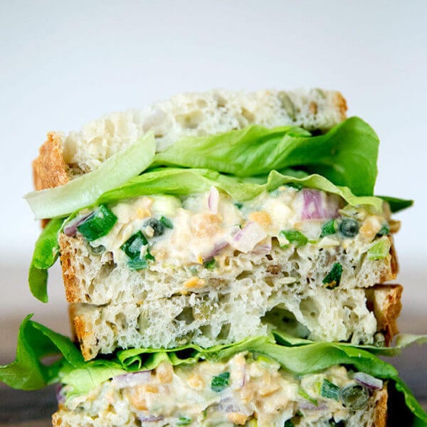 No-tuna "tuna" salad sandwich, cut and stacked on top of one another.