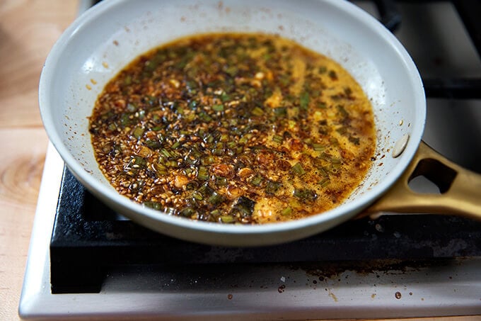 Sauce for the spicy broiled broccoli simmering in a small skillet.