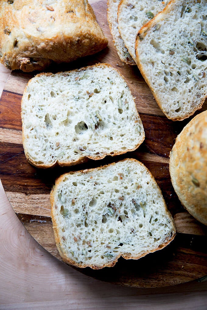 Sliced three-seed bread on a board.