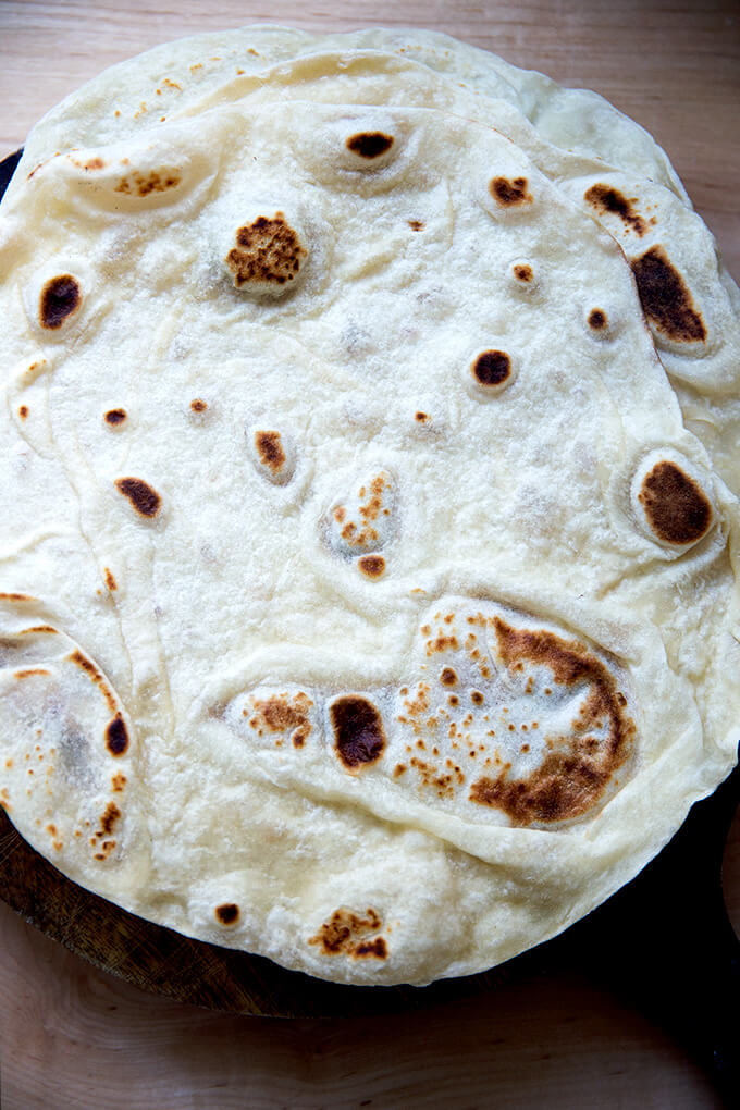 An overhead shot of a stack of homemade flour tortillas.