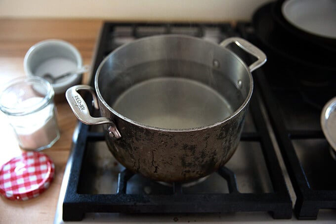 A pot filled with water, vinegar, salt and sugar.