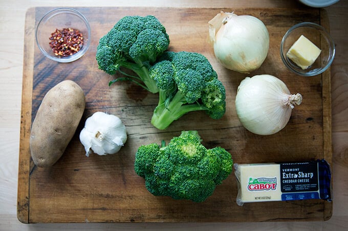 Ingredients on a board to make broccoli-cheddar soup.