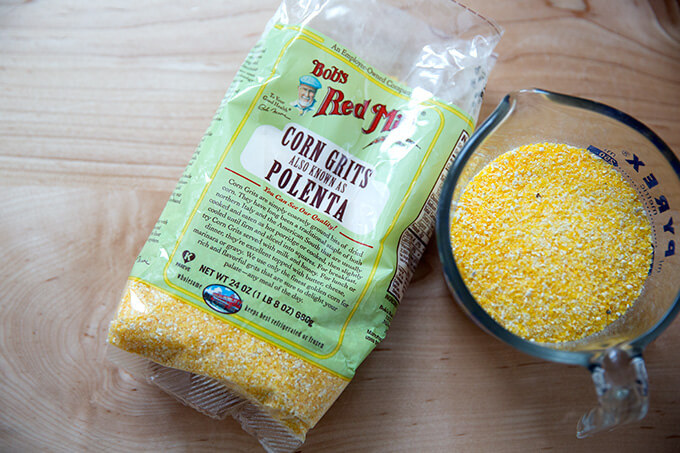 A bag and a measuring cup filled with polenta.