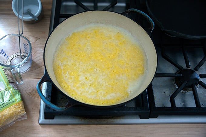 A skillet filled with bubbling polenta.