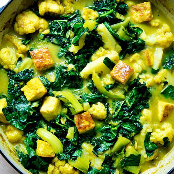 An overhead shot of a veggie and tofu curry in a skillet.