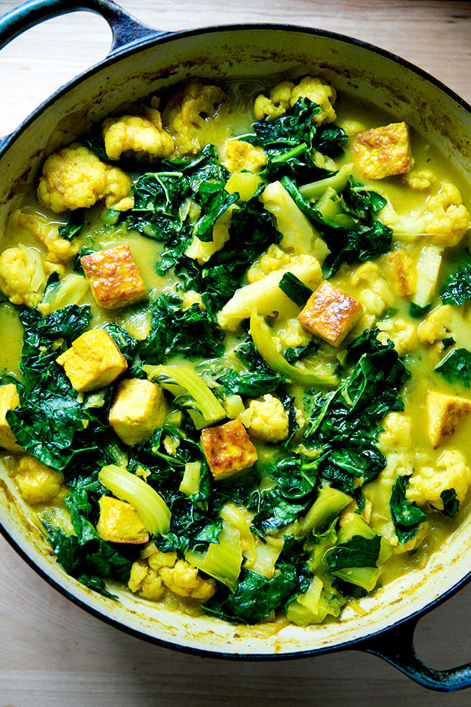 An overhead shot of a veggie and tofu curry in a skillet.