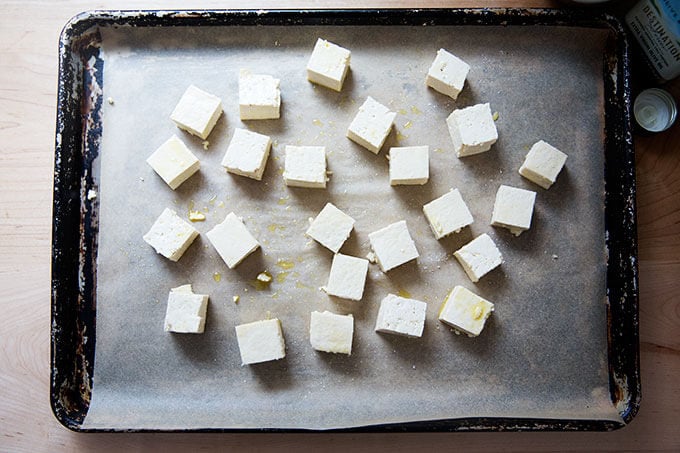 Cubed, seasoned tofu on a sheetpan.