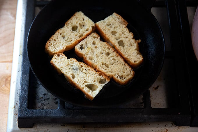 Sliced focaccia in a skilet.