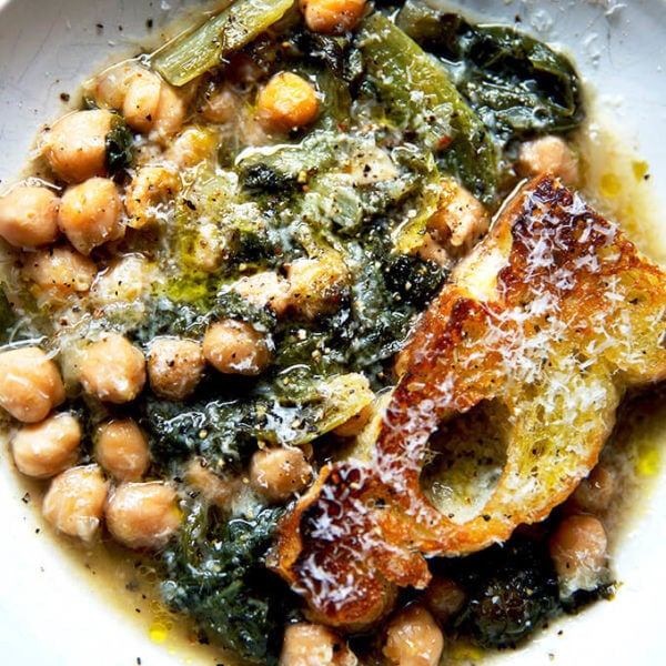 A bowl of chickpea and escarole soup with toasty bread.