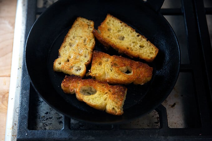 Olive oil toasted focaccia in a skillet.