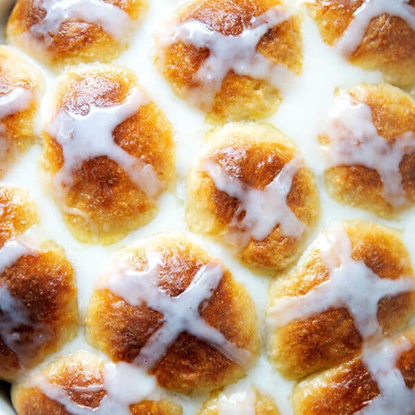 Up close of glazed hot cross buns.