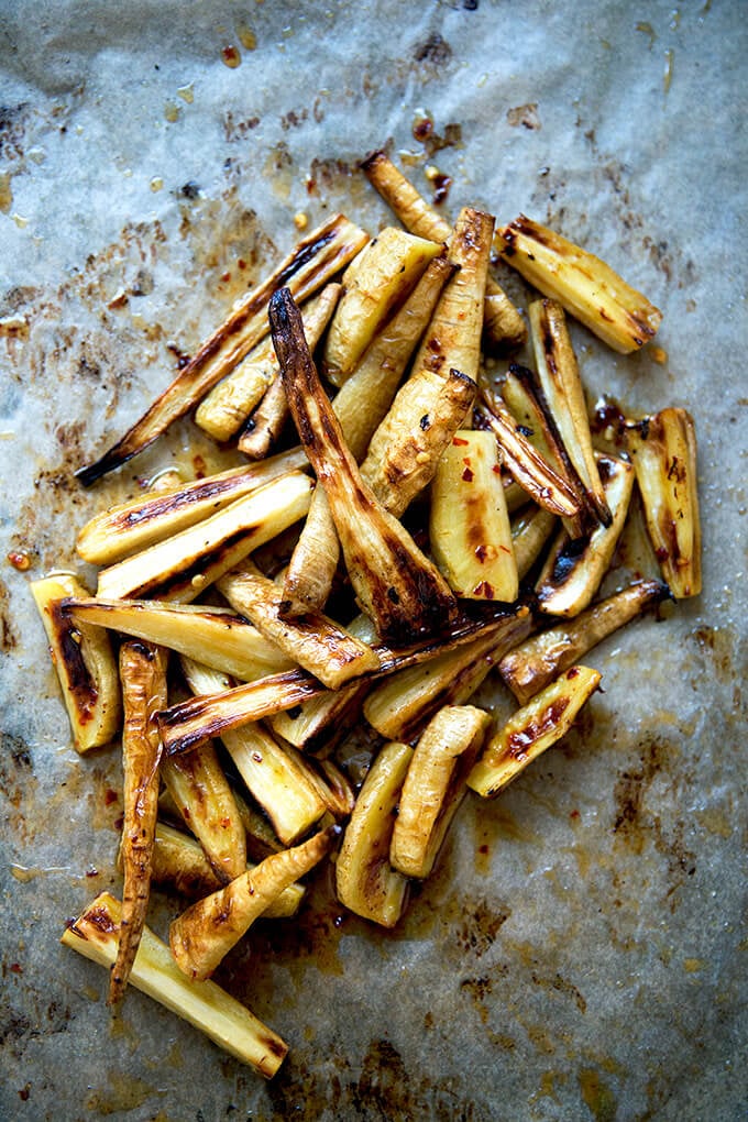 A sheet pan of just-roasted parsnips with chile-honey butter.