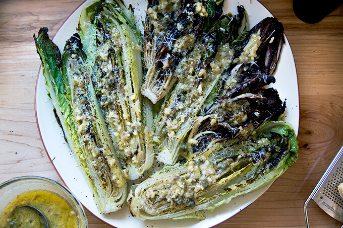 A platter of grilled Romaine and Treviso topped with anchovy dressing and parmesan.