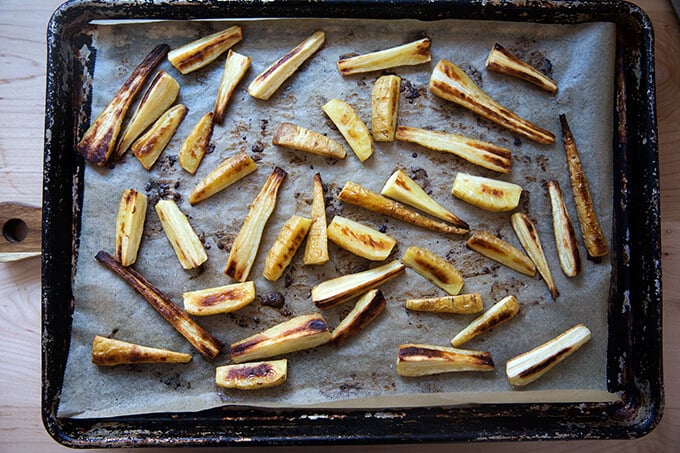 A sheet pan of roasted parsnips.